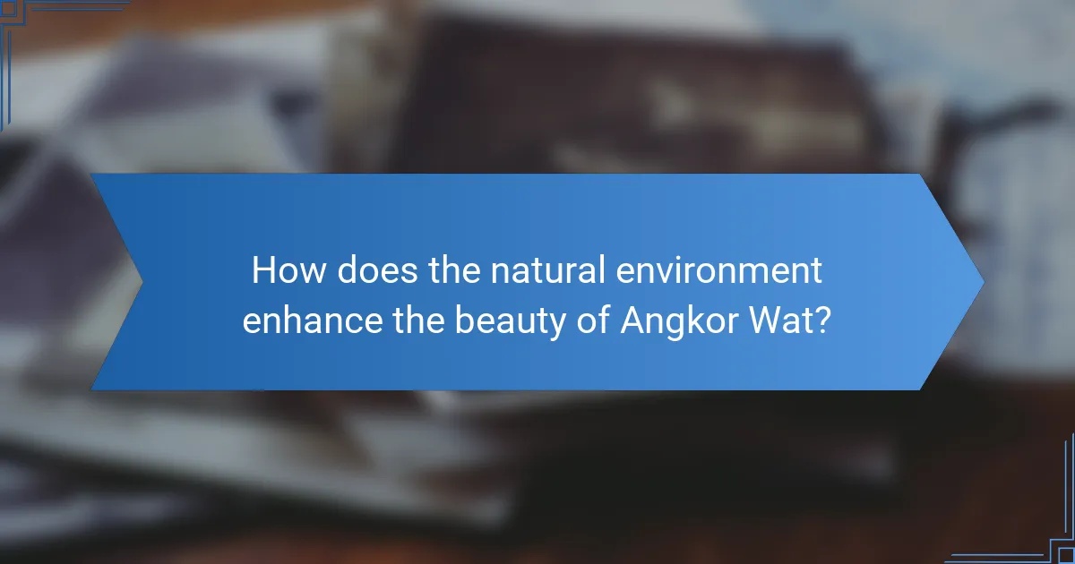 How does the natural environment enhance the beauty of Angkor Wat?